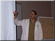Dr. Komor talking about a slide while teaching a seminar.